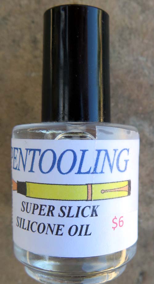 SILICONE OIL IN BOTTLE WITH BRUSH BUILT INTO THE CAP.
